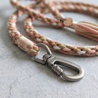 Detailed macro view of the Desert Mirage variant leash showing the premium metal trigger snap clip and decorative tassel end.