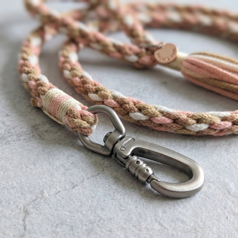 Detailed macro view of the Desert Mirage variant leash showing the premium metal trigger snap clip and decorative tassel end.