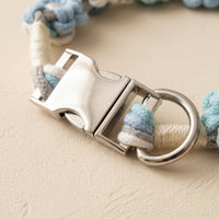 Detailed macro shot focusing on the polished silver side-release buckle and secure D-ring attachment point of a Paw's Line macrame floral collar.