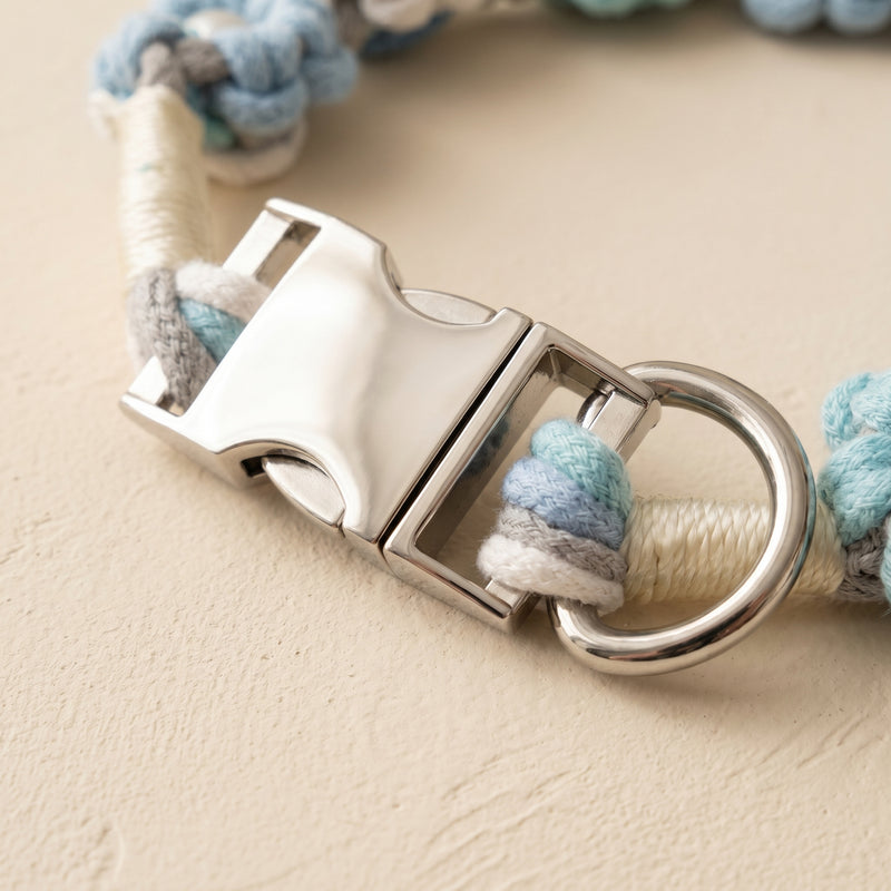 Detailed macro shot focusing on the polished silver side-release buckle and secure D-ring attachment point of a Paw's Line macrame floral collar.