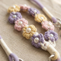 Close-up detail of the intricate woven flower macrame handle loop with pearl accents on a Paw's Line premium dog leash.